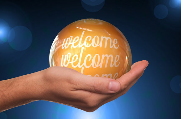 Image: Welcome written on globe, held in hand - E. John Robinson Official Site, Blog